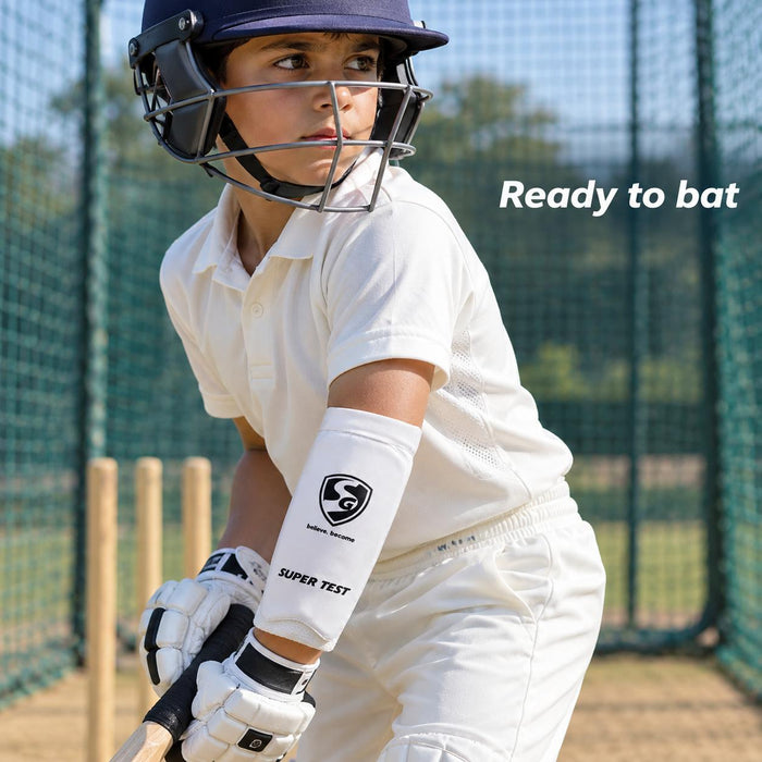 Junior boy batter wearing a white SG Super Test forearm elbow guard in practice nets