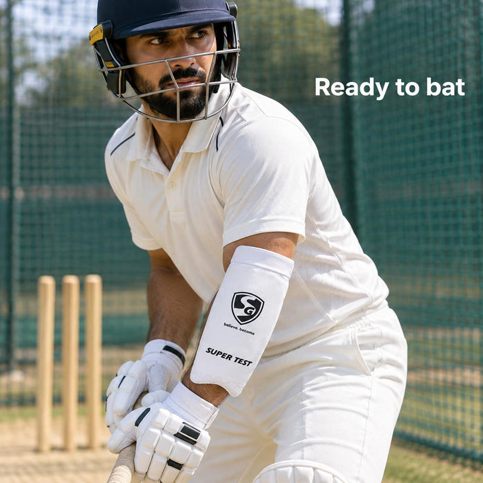 Adult batter wearing a white SG Super Test forearm elbow guard in cricket nets