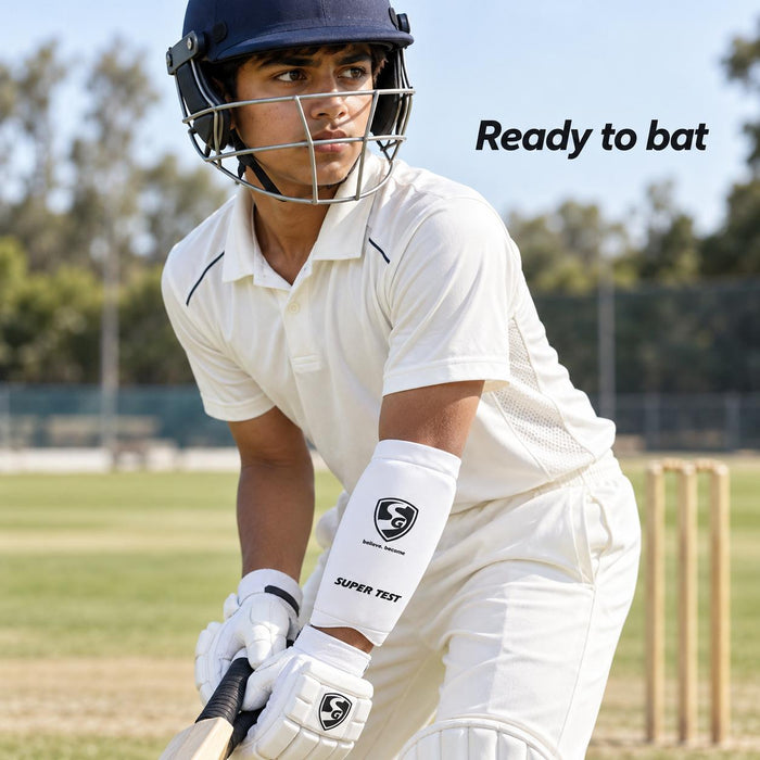Youth batter wearing a white SG Super Test forearm elbow guard on a cricket ground