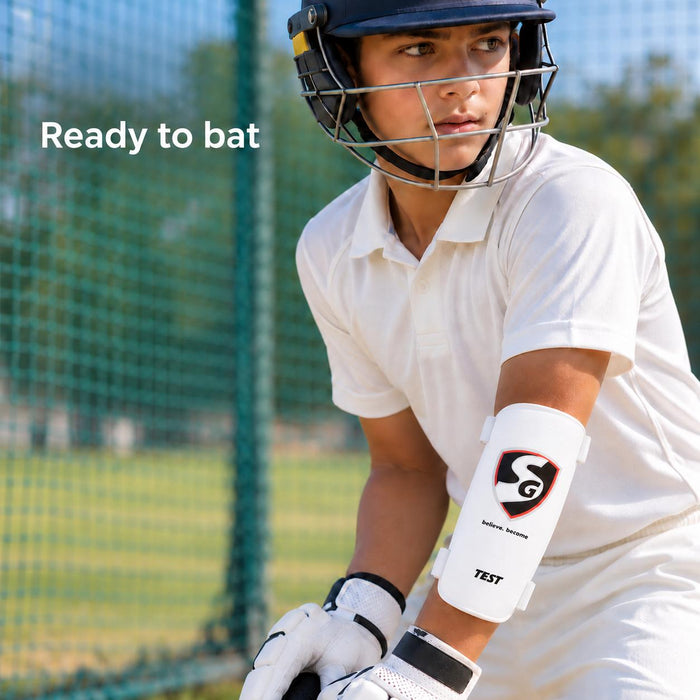 Youth cricketer wearing an SG Test forearm elbow guard in practice nets