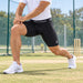 SG Xtreme black compression shorts worn during a cricket warm-up lunge