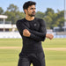 SG Xtreme black long-sleeve compression top worn during a cricket warm-up