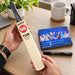 SS unsigned miniature autograph bat held beside the included autograph book and permanent marker
