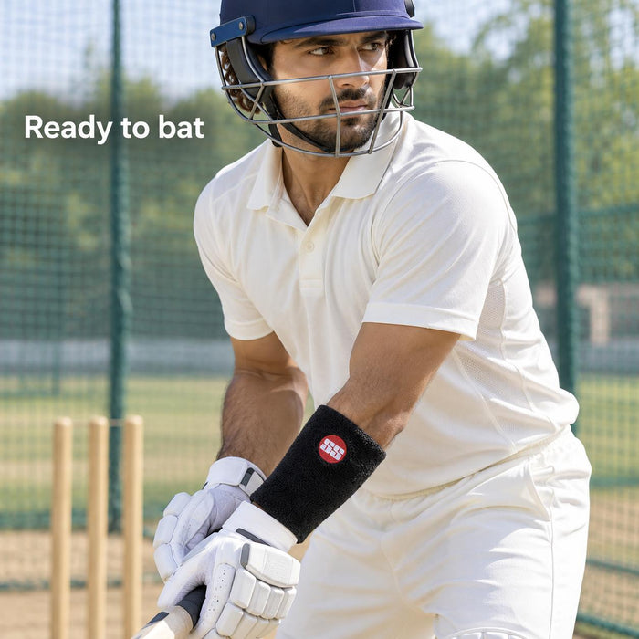 Adult cricketer wearing the black SS Premium Pro wrist guard above the batting glove in cricket nets