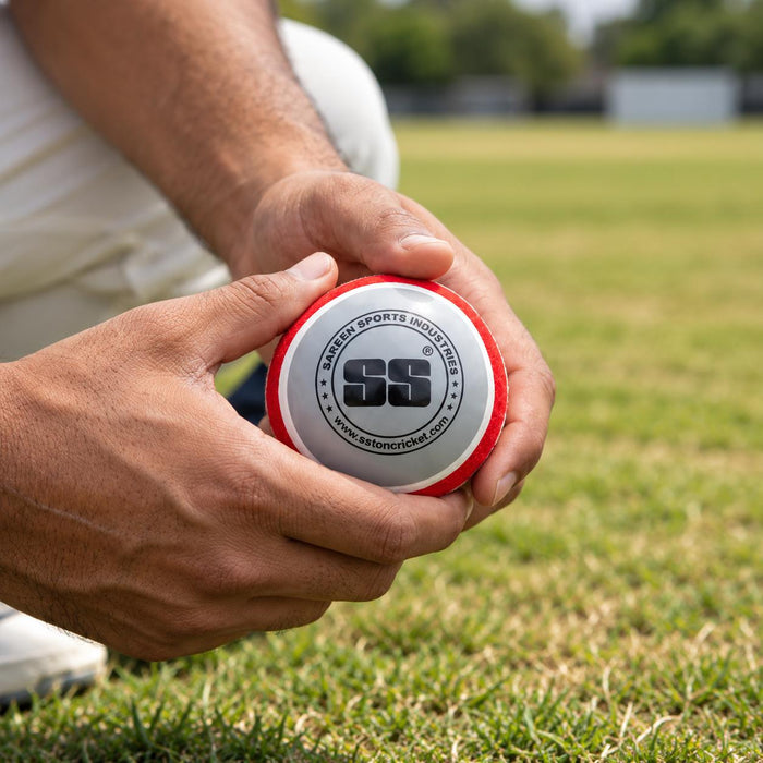 Hands holding SS swing ball before cricket training