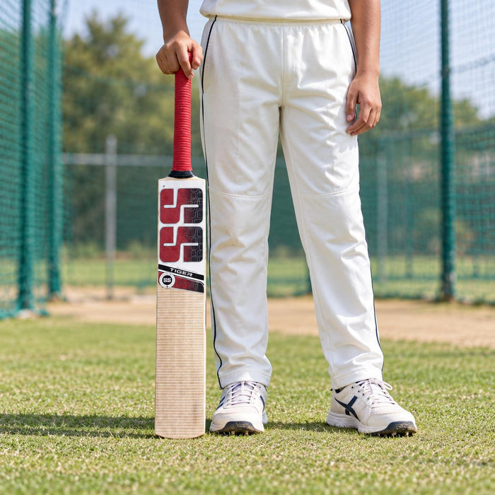 SS Tiger English Willow Junior Cricket Bat - Size 5 (five) held upright by a cricketer before practice