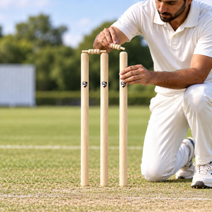 Cricketer placing the second bail on an SG Tournament wooden wicket