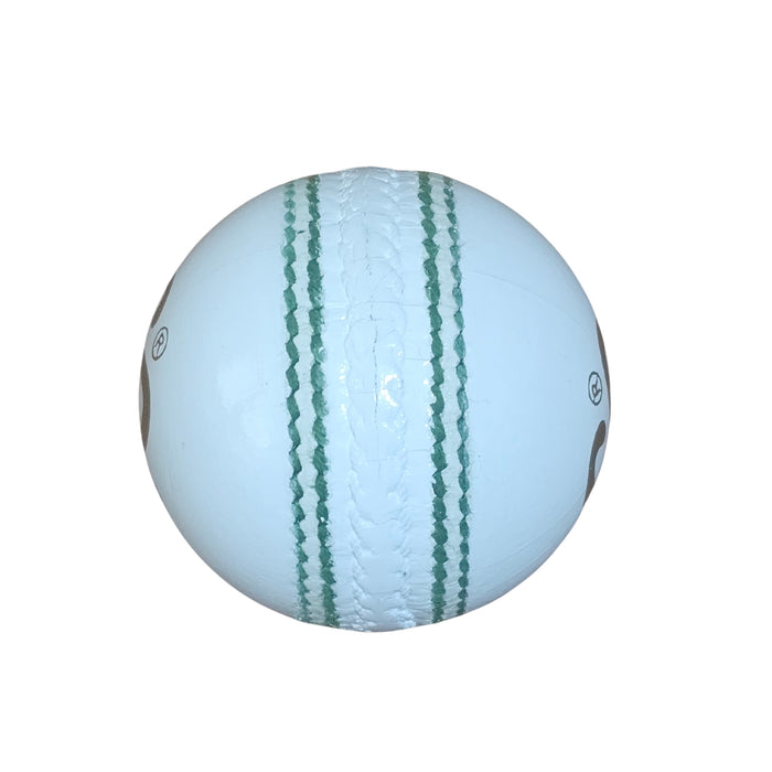 White leather cricket ball close-up of raised seam and green stitching
